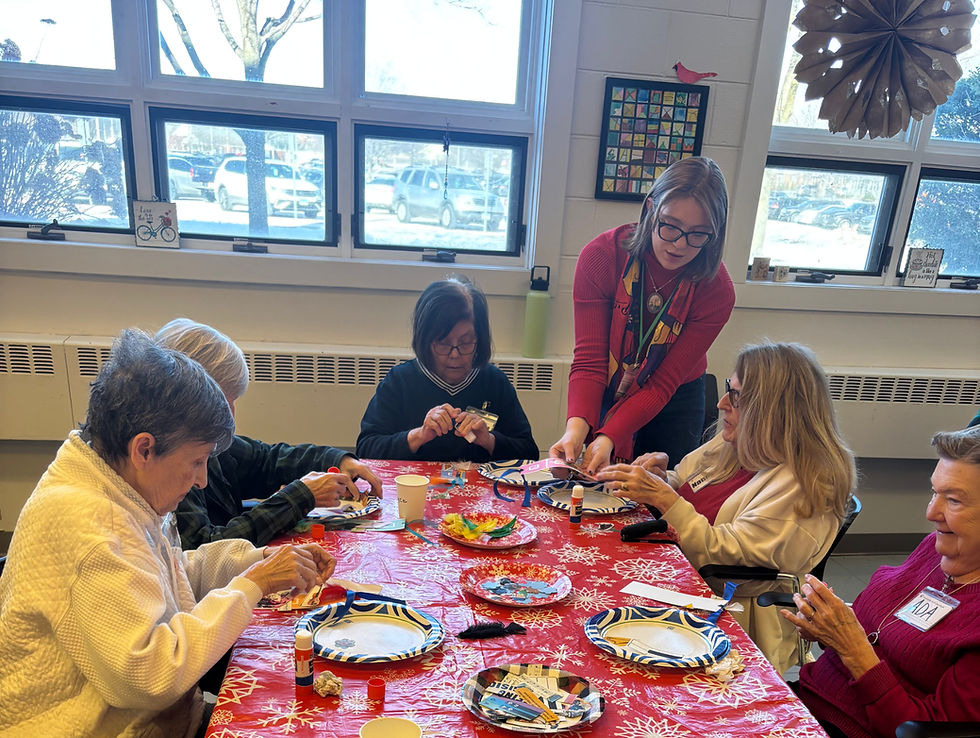 Volunteer helping Members make art