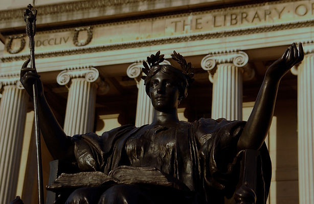 Up close photo of the statue of Alma Mater with the pillars of Low Library behind it.