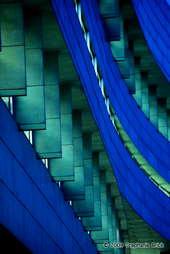 Photograph: Abstract, organic, blue-green lines of a metal building