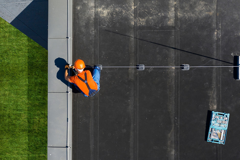 Roofer on a commercial roof looking at the work he just finished