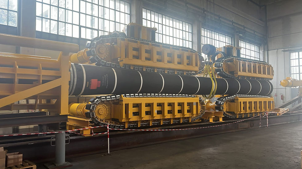Large industrial hose handling machinery inside a factory setting.