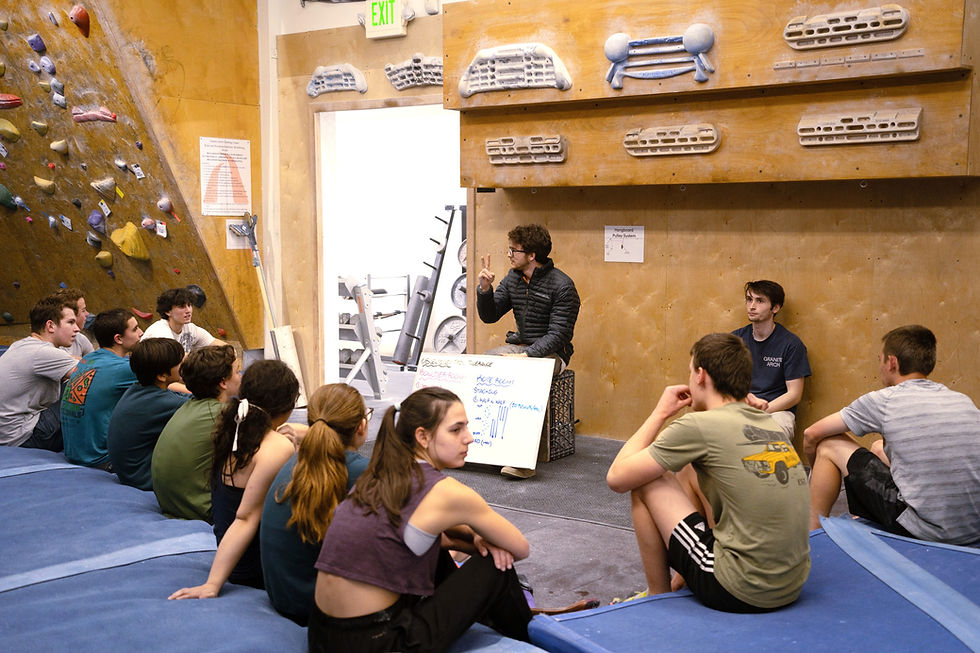 Kids gathered aroun their coach and listening to the lesson