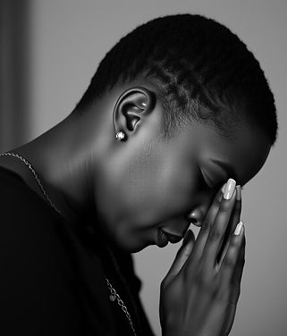 black woman with her head bowed and pray