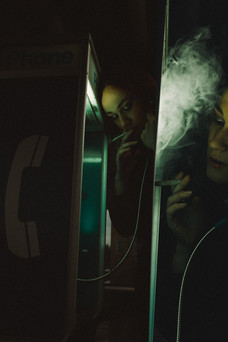 Composite of woman smoking in Portland transit phone booth