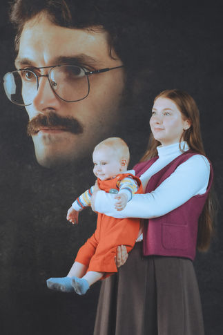 Awkward 80's style family portrait in Portland studio with child, mother, and floating dad head