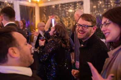 Excited guests dance at a wedding reception