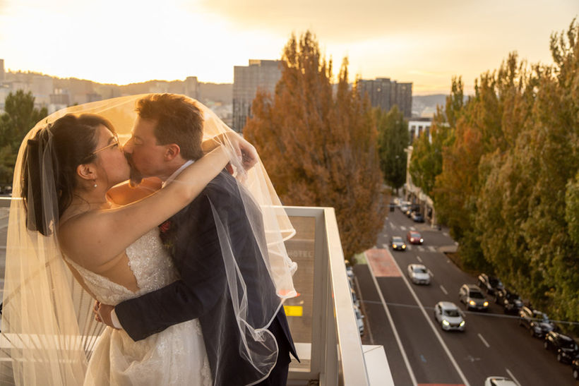 Bride and groom on Portland rooftop at Sunset