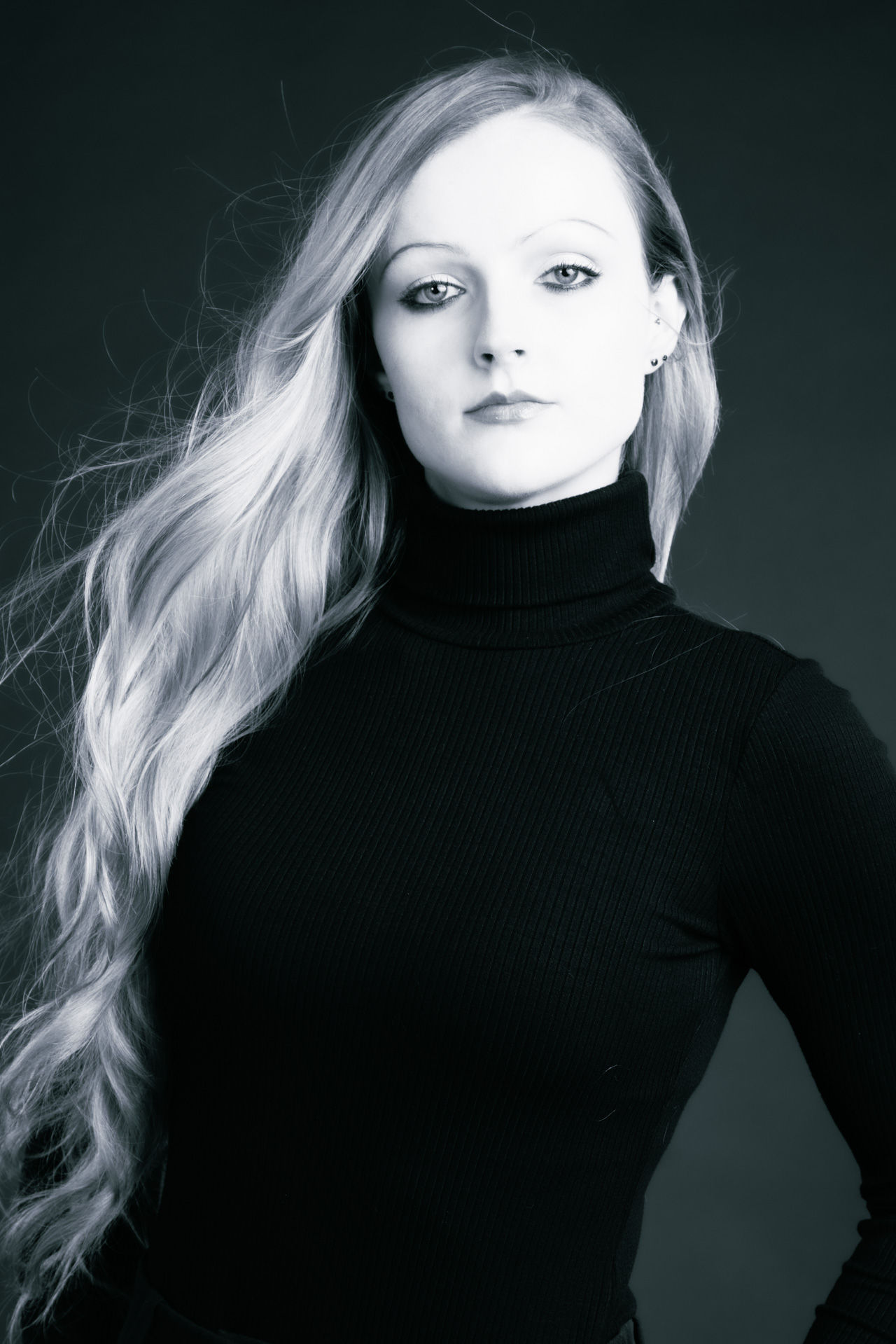 Beautiful woman in black in studio for professional corporate headshots