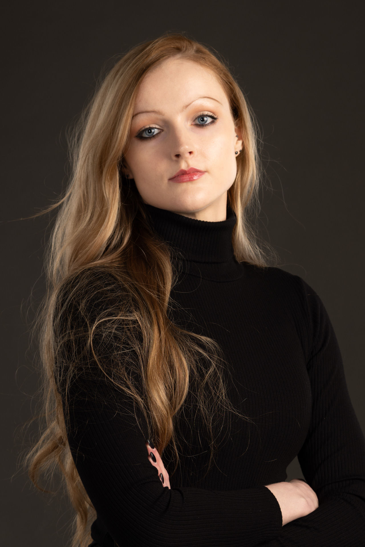 Beautiful woman in black in studio for professional corporate headshots