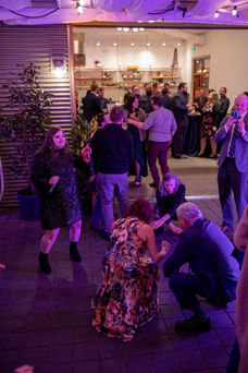 Excited guests dance at a wedding reception