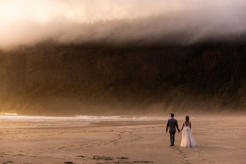 Epic bride and groom in sunset on Oregon Coast in sand