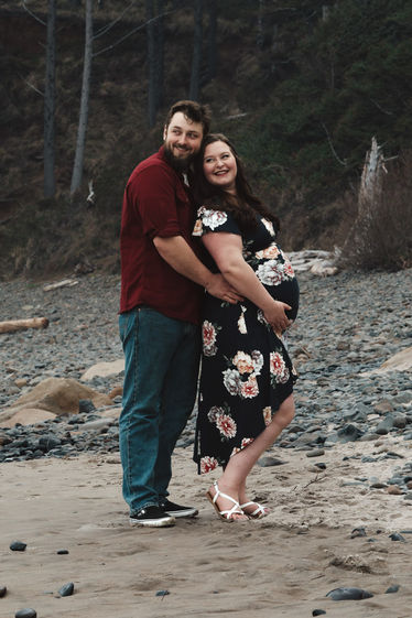 Maternity celebration and photoshoot on overcast Oregon coast