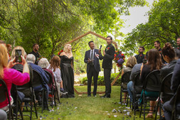Alternative wedding couple with black wedding dress and black suit at oregon farmhouse