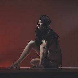 Dark gothic nude maternity on red