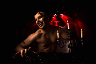 Devilish famous model under fine art red studio light at popular Portland photography workshop