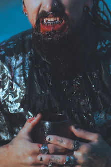 Bloody vampire holding glass and snarling