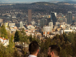 A wedding couple overlooks Portland skyline from wedding venue