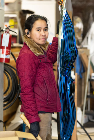 Candid creators in metal sculpting art studio of portland