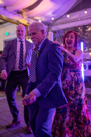 Excited guests dance at a wedding reception