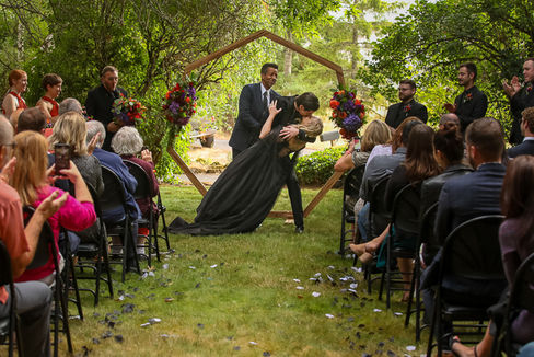 Alternative wedding couple with black wedding dress and black suit at oregon farmhouse