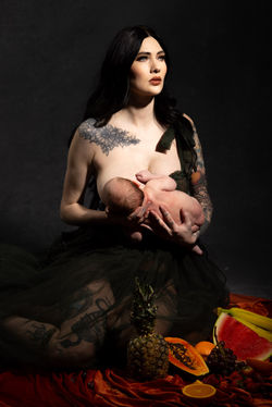 A beautiful woman breastfeeding her newborn son