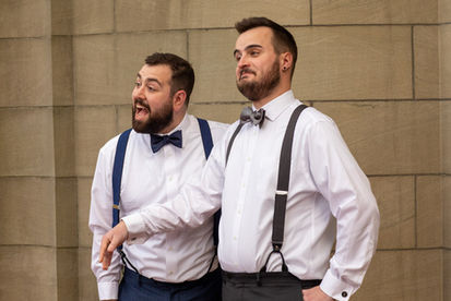 Gay couple on their wedding day in front of elegant Mansion