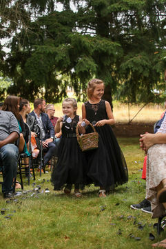 Alternative wedding couple with black wedding dress and black suit at oregon farmhouse