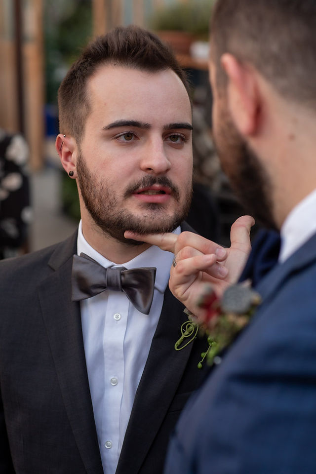 Groom lifts chin of his groom