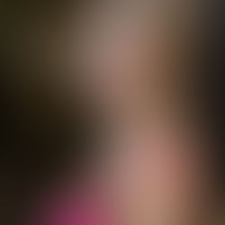 Senior student near Oregon waterfall in pink dress for senior portraits