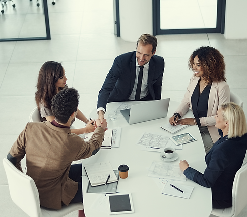 Two professionals shaking hands during a New Worker Workshop, symbolizing successful onboarding and workplace integration.
