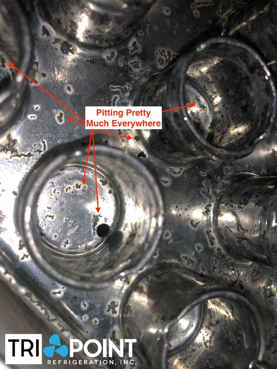round metal evaporator openings with pitting everywhere