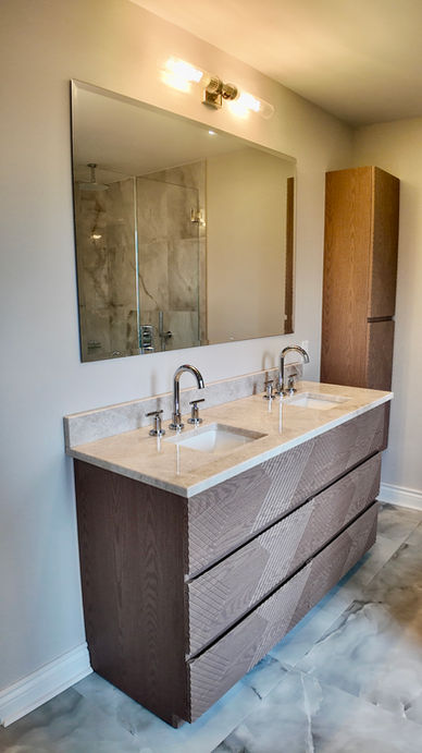 White washbasin with black taps in front of a wooden wall