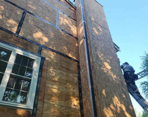 Redoing plywood on chimney to support siding in Derry New Hampshire.