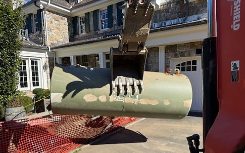 Exposed underground storage tank prepared for pump-out during removal process