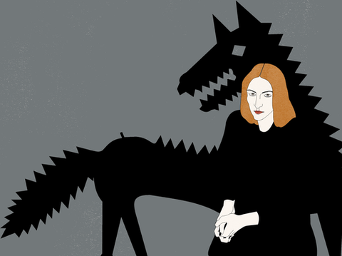red-haired woman sitting and big, black wolf