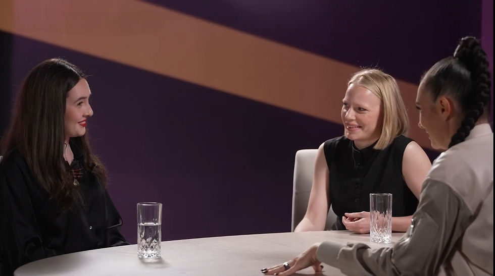 Three women sit at a roundtable discussion on a podcast.