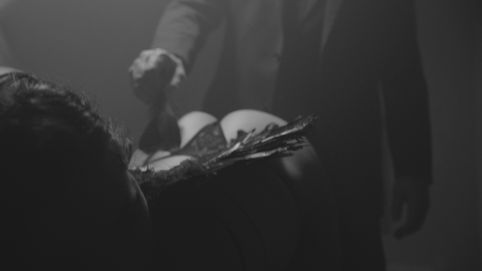 An angel being teased with her own plucked wing feather.