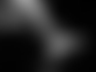 Abstract close-up boudoir photography portrait in black and white, highlighting the textured lace bodysuit and the soft curve of a client's hips and thigh as patterned window shadows fall across the skin.