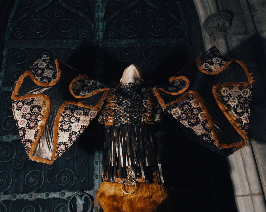 Avant-garde conceptual fashion design and stylized fashion photography in NYC in front of a cathedral, dramatic dynamic photograph