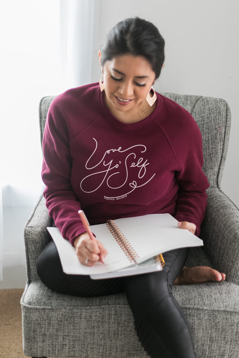 Boudoir photographer writing in planner