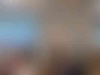 Two presenters at a conference with a screen and a banner.