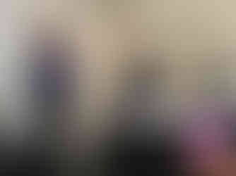 a woman delivering a presentation at the University of Manchester. She's holding a microphone and there's a laptop on the desk in front of her.