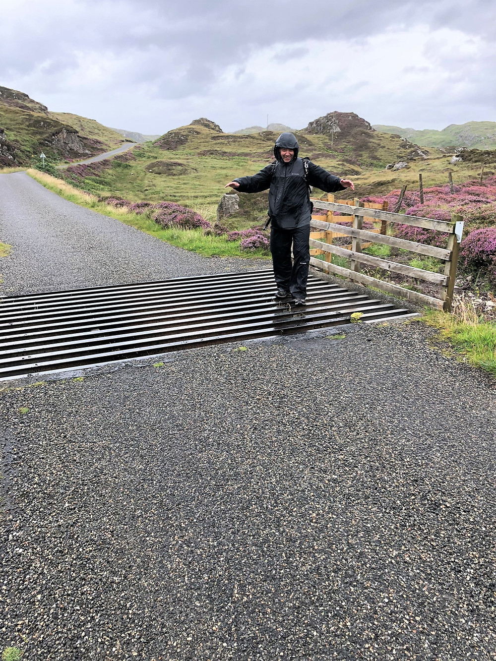 Walking in strong winds and rain the single track road to Breascleit on the Great Bernera Loop trail in the Outer Hebrides