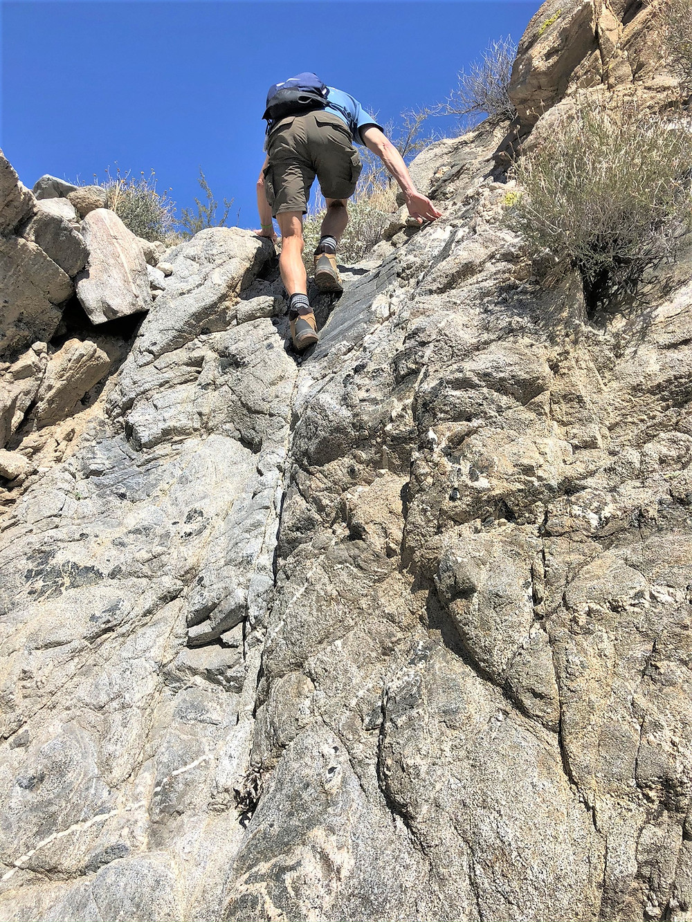 Scrambling up rock face in Swiss Canyon in Little San Bernardino mountains