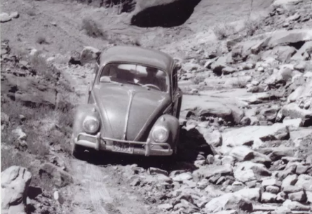 1965 photo of Volkswagen Beetle driving the Shafer Rod in Canyonlands National Park