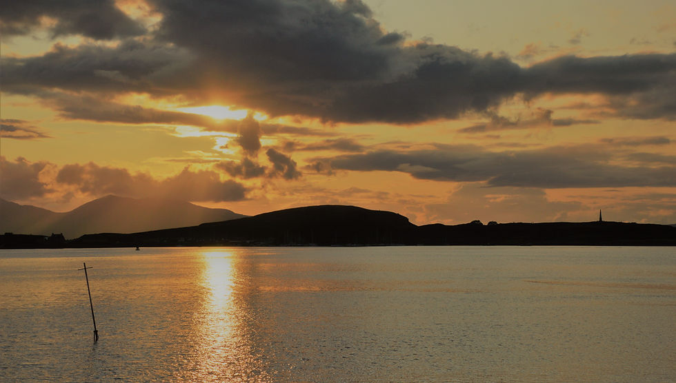 Sunset over Oban harbor in Scotland
