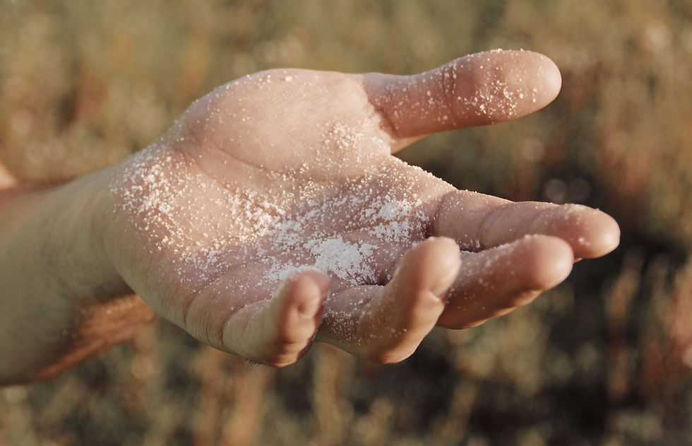 Hand reaching out with salt on it