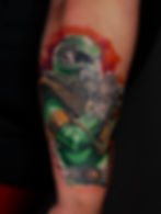 Green Power Ranger tattoo on arm
