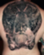 Black and grey Odin tattoo on a man's back