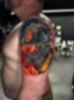 Firefighter tattoo with US flag and flames on arm